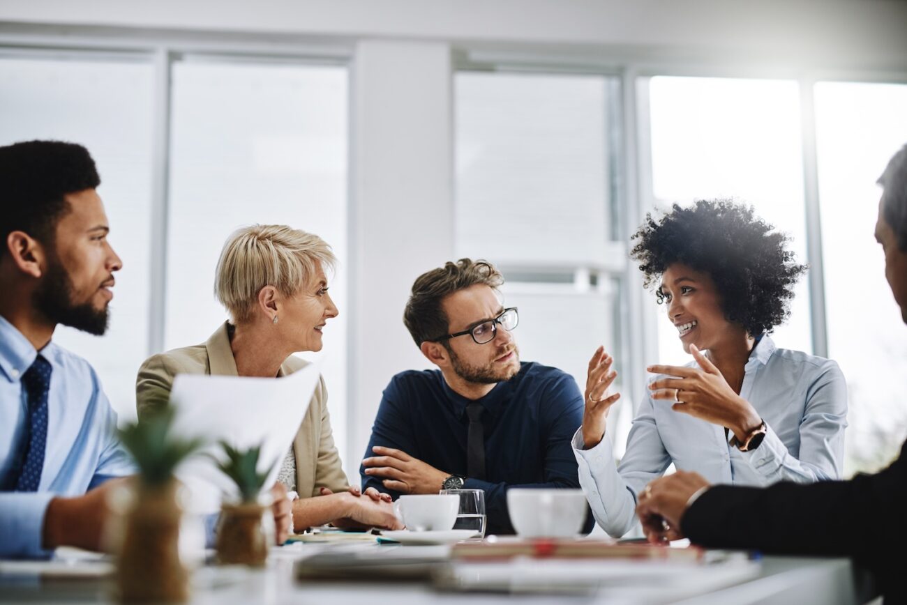 i need everyone to give me their best ideas shot of a group of businesspeople sitting together in a meeting